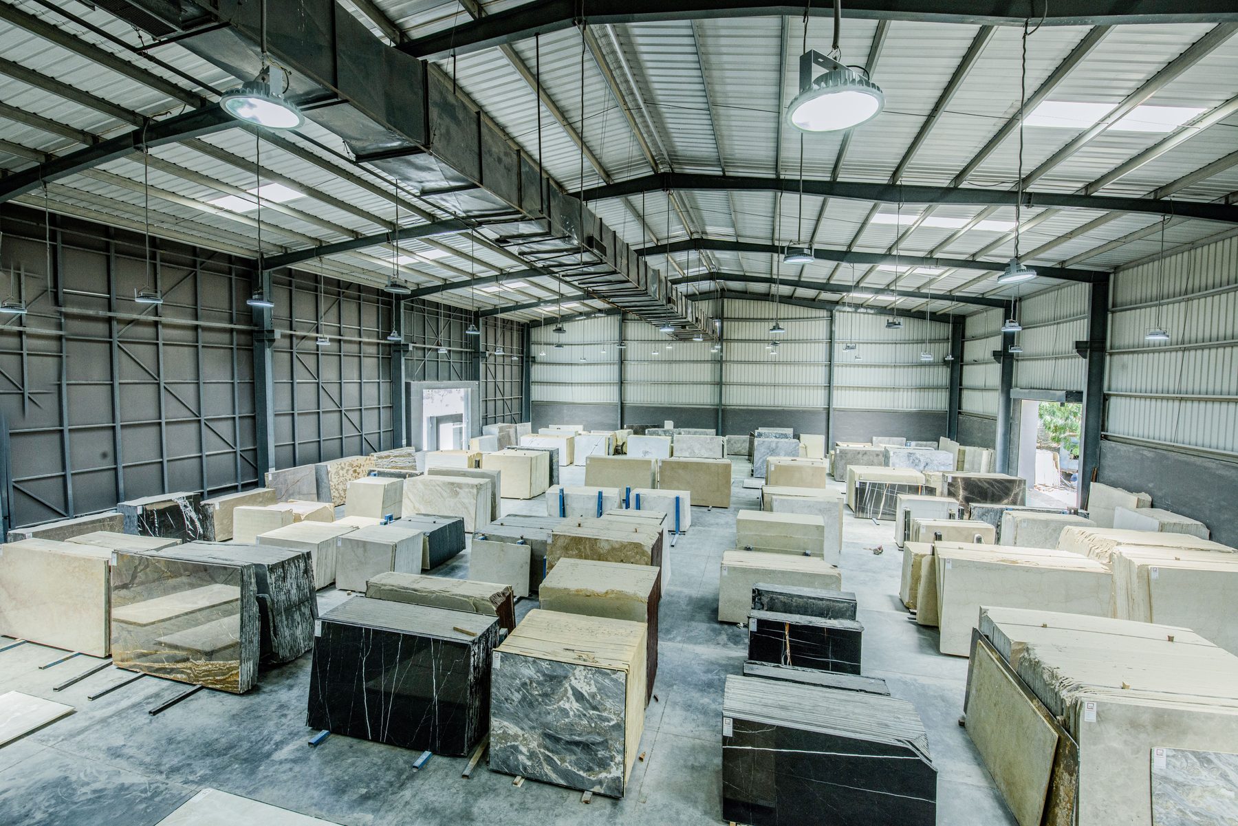 Natural stone blocks arranged inside a modern warehouse